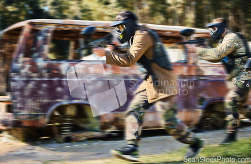 Image of Paintball, team work or people running in shooting game with speed or fast action on a fun battlefield. Mission focus, blurry caravan or men with guns for survival in competition in nature or forest