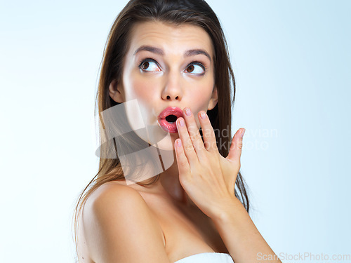 Image of Wow, hand and woman surprised, shocked and omg expression for skincare results on blue background. Face, wtf and girl model with open mouth emoji for makeup, glamour and luxury cosmetic isolated