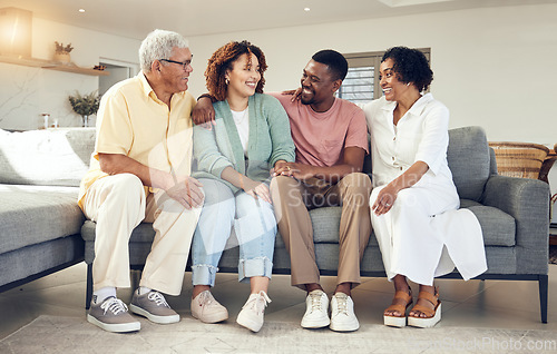 Image of Happy family, parents and couple relax on a sofa, talking and laughing while bonding in a living room. Woman, man and seniors on a couch, happy and smile while enjoying weekend and retirement at home
