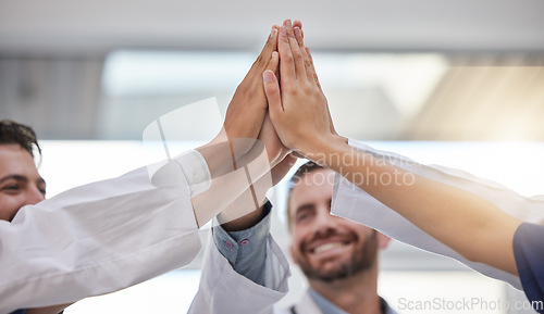 Image of High five, doctors and hands of teamwork, success and celebrate medical goals in clinic. Healthcare group, support and motivation of achievement, partnership and hospital collaboration of celebration