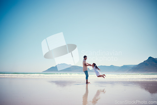 Image of Mockup, father and daughter playing on the beach together during summer vacation or holiday by the ocean. Sky, sea or view with a man and female child swinging while bonding on the sand at the sea