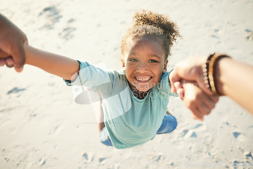 Image of Pov, happy and father spinning child while at the beach on a summer vacation, adventure or weekend trip. Happiness, freedom and man swinging a girl kid on the sand while having fun on seaside holiday