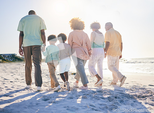 Image of Family walk on the beach, holding hands and generations with travel and summer vacation, solidarity and love outdoor. Grandparents, parents and children on holiday, people together with back view