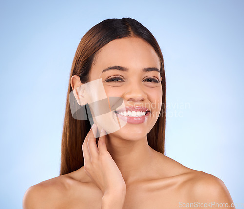 Image of Portrait, smile and woman with dermatology, cosmetics and grooming against blue studio background. Face, lady and female with happiness, natural and salon treatment for morning routine and soft skin