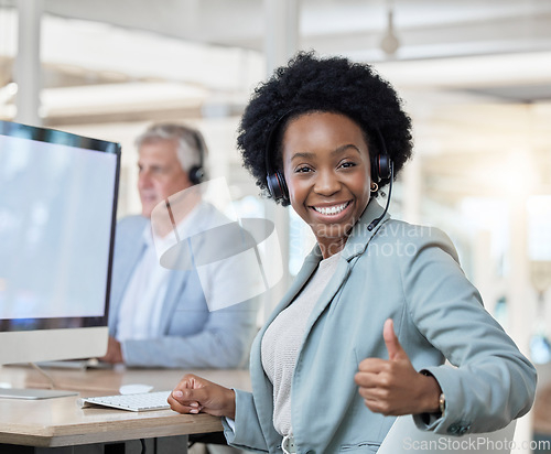 Image of Happy, portrait and black woman in a call center with a thumbs up for online support and thank you. Smile, success and African customer service worker with an emoji hand gesture for achievement