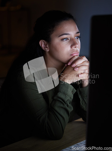 Image of Serious, night and woman on computer in office, working late on online project, proposal and planning. Concentration, thinking and female reading screen for internet, network or website research