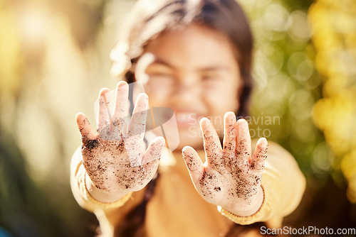 Image of Dirt soil hands, girl child and gardening mockup with blurred background with smile, happiness and outdoor. Kid, garden development and backyard for sustainability, learning and ecology for growth