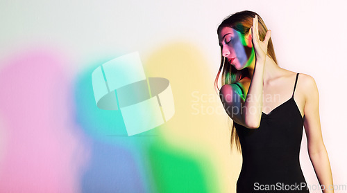 Image of Light, beauty and fashion with woman in studio for creative, aesthetic or neon glow. Kaleidoscope, cosmetics and disco with model and cmyk color shadows for designer, art or party on white background