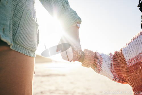 Image of Family, mother and child holding hands at beach, travel and summer with sunshine lens flare and together outdoor. Trust, support with woman and girl on vacation, love and care in nature with closeup