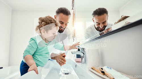 Image of Cleaning, washing hands and father with baby in bathroom for hygiene, wellness and healthcare at home. Family, skincare and dad with child learning to wash with water, soap and disinfection by faucet
