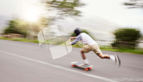 Image of Skateboard, moving and man with motion blur for sports competition, training and exercise on street. Skating, skateboarding and male skater riding for speed, adventure and adrenaline in extreme sport