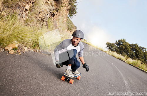 Image of Skateboard, travel and mountain with man in road for speed, freedom and summer break. Sports, adventure and wellness with guy skating fast in street for training, gen z and balance in nature