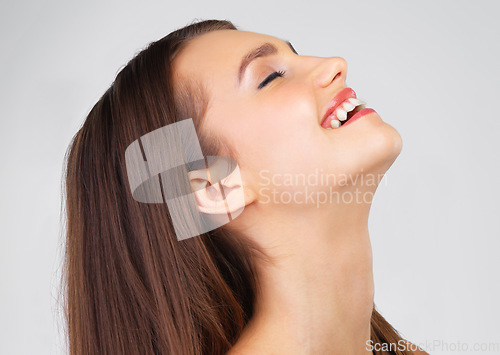 Image of Skincare, funny and woman with beauty, happy and dermatology against a grey studio background. Female, makeup and confident lady laughing, grooming and luxury treatment for smooth, clear or soft skin