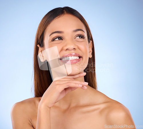 Image of Skincare, beauty and cosmetics, face of hispanic woman, smile and skin glow promo on blue background. Makeup, facial product placement and model in studio for dermatology spa promotion with mockup.