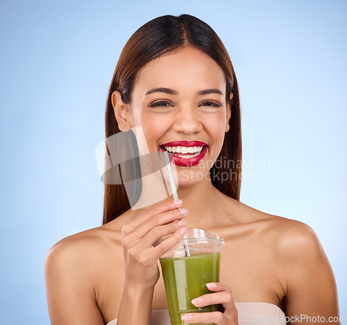 Image of Beauty, smoothie and health with portrait of woman in studio for detox, nutrition and diet, Happy, smile and minerals with girl model and green juice on blue background for vegan, fiber and protein