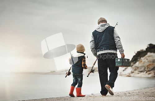 Image of Walking, back and child with grandfather for fishing, bonding and learning to catch fish at the beach. Morning, holiday and boy on a walk by the sea with an elderly man to learn a new hobby together