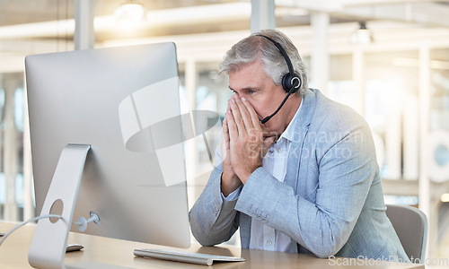 Image of Call center, customer service and anxiety with a consultant man suffering from stress while working in the office. Crm, support or burnout with a senior male telemarketing working feeling overwhelmed