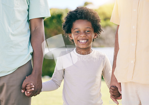 Image of Portrait of kid, smile and holding hands of parents, happy in backyard garden and support, trust and love in adoption diversity. Family, children and biracial couple with black child in park together