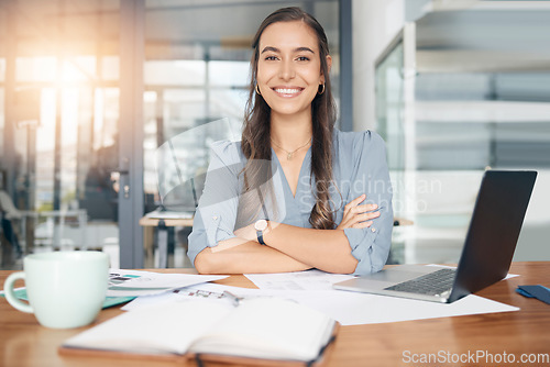 Image of Business woman, portrait and smile at desk in office for paperwork, laptop or administration in Canada. Happy, young or confident female worker with pride planning project at table in startup company