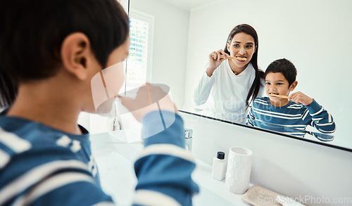 Image of Happy family, woman and boy in bathroom for brushing teeth, healthcare and bonding to start morning in house. Young kid, mother and teaching with toothbrush, smile and mirror for medical self care
