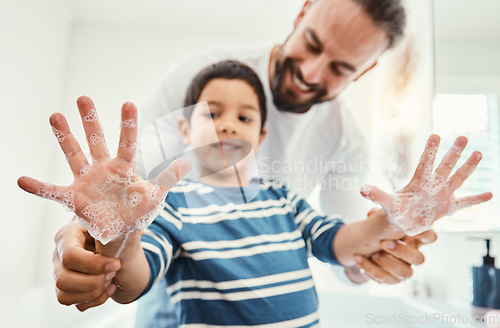 Image of Hands, soap and father with boy in bathroom for hygiene, wellness and healthcare at home. Family, skincare and dad with child smile learn to washing palms with water, foam and disinfection by faucet