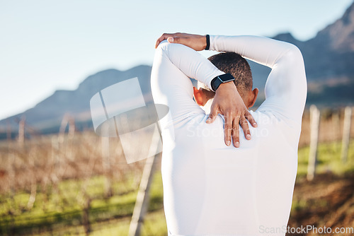 Image of Man, stretching before running and fitness outdoor with hiking or run in countryside, exercise and warm up. Arms, muscle and strong male with back view, start with race for marathon or trekking