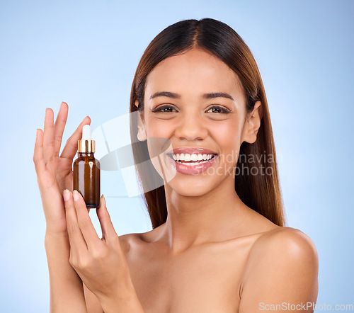 Image of Skincare, beauty and portrait of happy woman with serum for anti aging or skin glow on blue background. Cosmetics, facial repair and face of model with solution or collagen product on blue background
