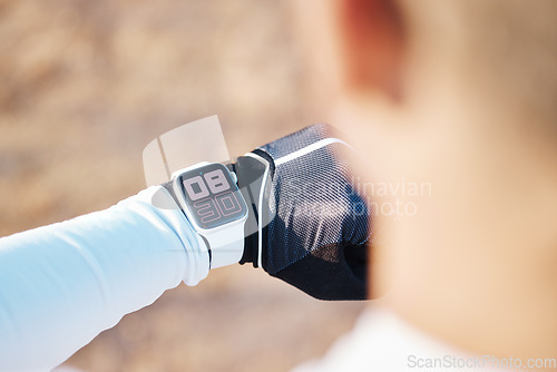 Image of Watch, active and time on hand of person in a race as a stopwatch during exercise, sports and workout outdoors. Tracking, tracker and smartwatch on male athlete or runner timing his training session