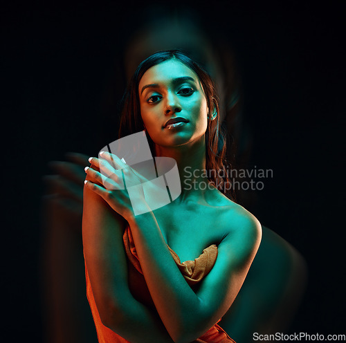 Image of Green light, fashion and Indian woman with beauty, glowing skin and luxury brand aesthetic. Creative lighting, young female and model with a dark background in a studio with modern style and makeup