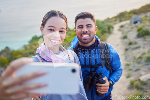 Image of Man, woman and hiking selfie with smile, love and happiness in nature for outdoor adventure on holiday. Young happy couple, blog and mountain for care, bonding and vacation with social media app