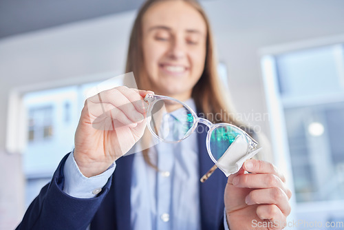 Image of Hands, glasses and an optometrist woman cleaning lenses in a store to sell a product for fashion. Vision, eyewear and optometry with a female optician wiping a pair of frame eyeglasses for eyesight