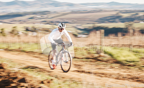 Image of Man, bicycle and cycling with motion blur in nature, countryside and training for triathlon, sports and power. Cyclist, mountain bike and speed for off road travel, exercise or professional challenge