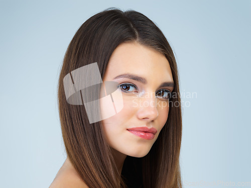 Image of Makeup, beauty and portrait of woman with cosmetics on blue background for wellness, skincare and facial. Salon aesthetic, dermatology and face of girl with spa treatment, hair care and glamour