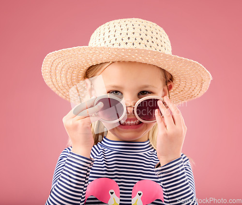 Image of Vacation, portrait of child in studio with sunglasses and fun clothes and hat isolated on pink background. Summer, holiday and fashion, happy girl in Australia excited for travel with smile on face.