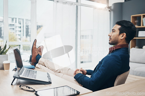 Image of Office, feet up and businessman working on laptop, thinking and unsure of design or proposal. Unsure, doubt and pensive leader relax while contemplating, brainstorming or deciding mission plan