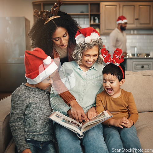 Image of Happy, christmas and family looking at a photo album for memories, nostalgia and bonding. Smile, festive and mother, grandmother and children excited to look at pictures of relatives in a book