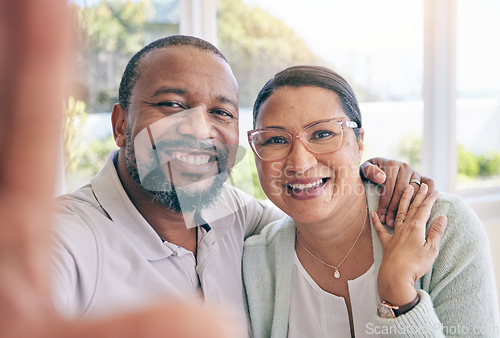 Image of Happy, mature and portrait of an interracial couple with a selfie for a memory, together and relationship. Smile, love and a black man with a woman taking a photo, looking and joyful at home