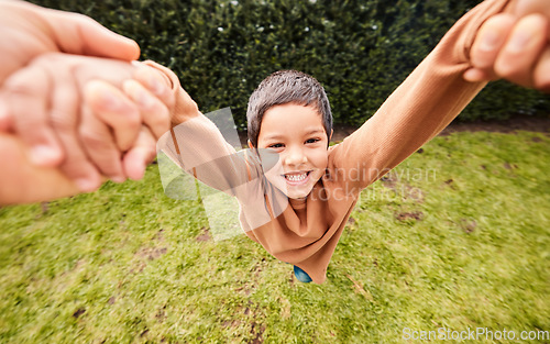 Image of Playing, happy and portrait of a child swinging with hands from a parent for fun and bonding. Smile, playful and carefree boy kid in a fast swing while holding hands with mom or dad in a garden