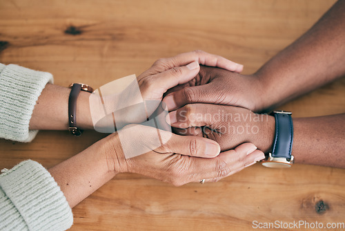 Image of Closeup of couple holding hands for support, empathy and help with news, depression or mental health problem. Therapy, psychology and depressed, sad or anxiety of mature man and woman hand together