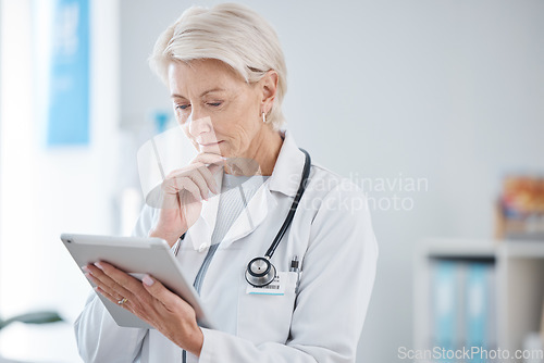 Image of Healthcare, tablet and senior doctor thinking in hospital for online consulting, telehealth and wellness app. Clinic, medicine and woman on digital tech for internet, medical research or patient data