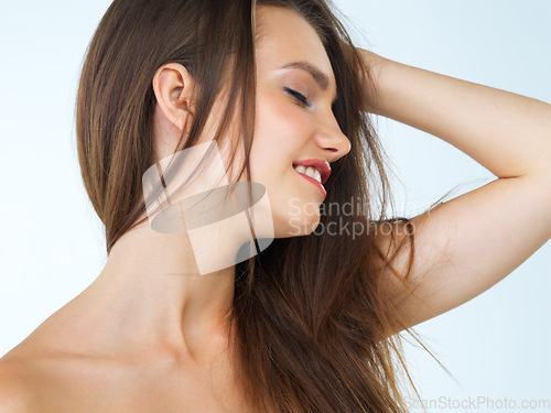 Image of Beauty, hair and happy woman in studio for treatment, natural and cosmetics against blue background. Smile, haircare and girl model relax after luxury, keratin or brazilian satisfaction isolated