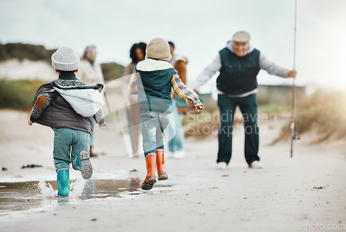 Image of Happy, running and family at the beach for fishing, freedom and excited about vacation. Smile, greeting and kids at the ocean with grandfather, parents and grandmother to fish during a holiday