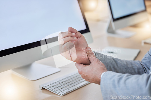 Image of Hand, arthritis and joint pain with a business man in his office, sitting at a desk suffering from carpal tunnel. Stress, medical or anatomy and a male employee struggling with osteoporosis or injury