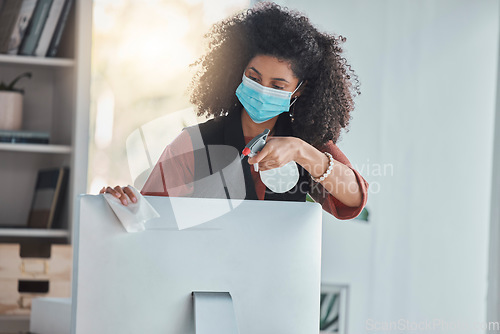 Image of Covid, compliance and a black woman cleaning her computer in the office for health, safety or control. Business, bacteria and regulations with a female employee wiping her desktop pc for disinfection