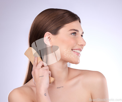 Image of Hair care, beauty smile and woman with brush in studio isolated on a gray background. Cosmetics, thinking and happy female model with sustainable wooden hairbrush for salon treatment or hairstyle.