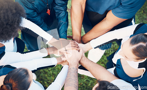 Image of Above, hands and friends in sports huddle for support, collaboration or team building mission. Top view, people and hand connect for teamwork, motivation and cooperation, agreement and training goal