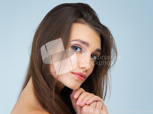 Image of Makeup, beauty and portrait of woman in studio on blue background for wellness, skincare and facial treatment. Salon aesthetic, dermatology and face of girl with cosmetics, confidence and glowing