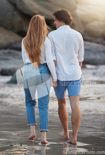 Image of Couple walking on beach, holding hands and travel with love and commitment in relationship, adventure and romance. Trust, partnership and care with people outdoor, tropical holiday and back view