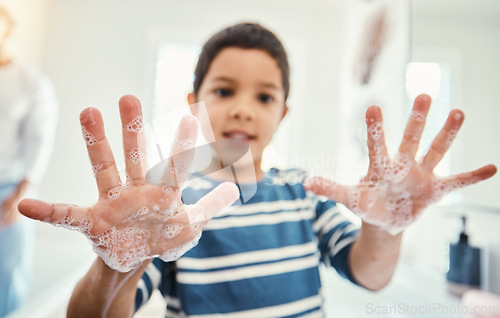 Image of Cleaning, hands with soap and boy in bathroom for hygiene, wellness and healthcare at home. Healthy family, skincare and portrait of child with open palms washing with water, soap and disinfection