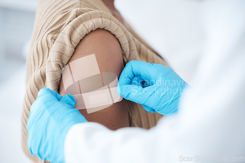 Image of Doctor, vaccine and woman with plaster on arm for healthcare, wellness services and medicine. Immunity injection, bandage and medical healing in hospital, surgery and clinic consulting of vaccination